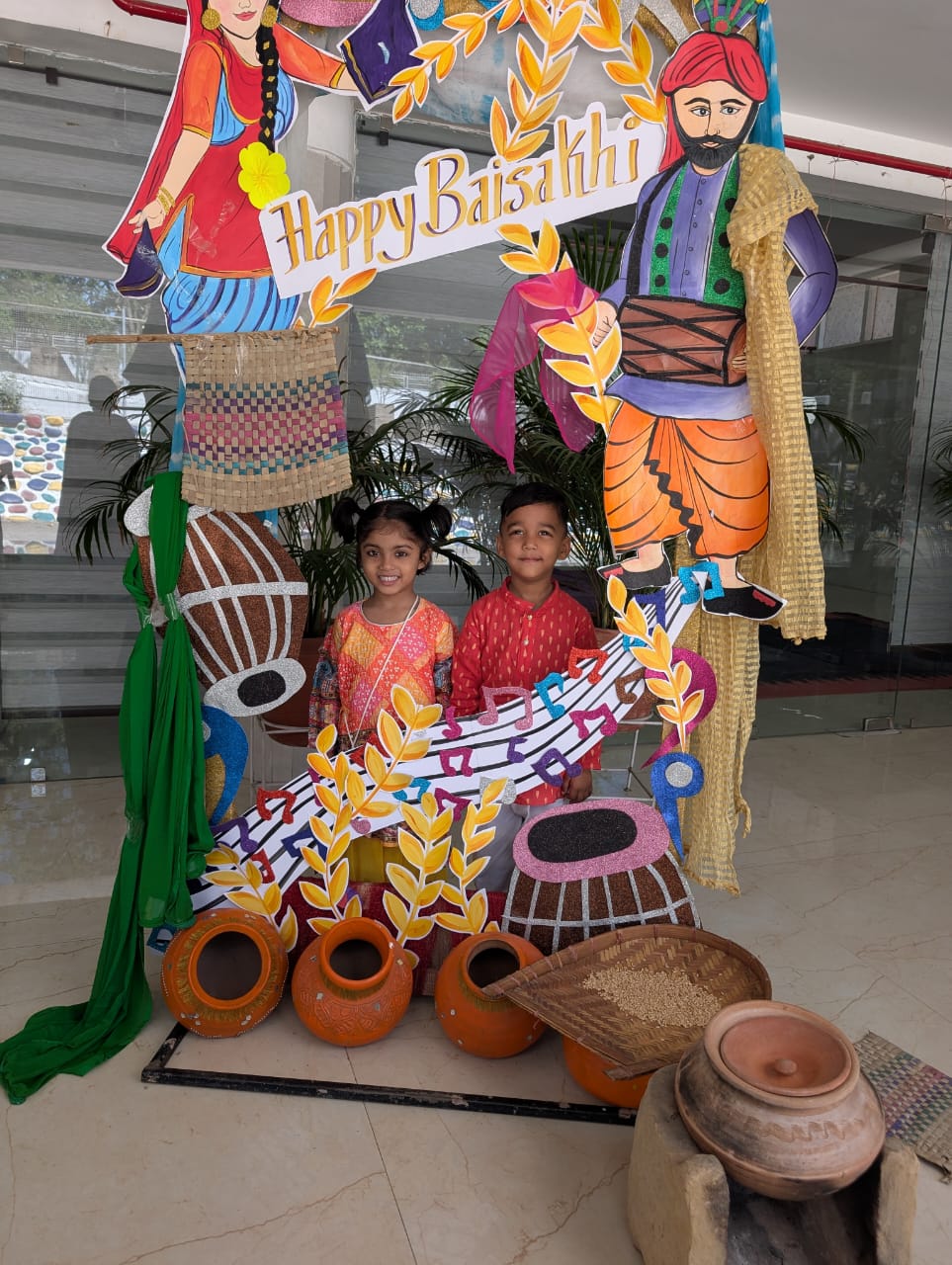 Children posing with traditional pots and grain